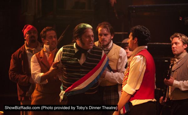Javert (Lawrence B. Munsey) - center - is exposed as a police spy. Left to Right: David Bosley-Reynolds, Nick Lehan, Lawrence B. Munsey, Will Emory, John Dellaporta, Jeffrey S. Shankle