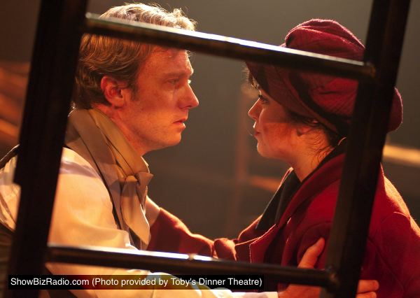 Marius (Jeffrey S. Shankle) pleads with Eponine (MaryKate Brouillet) to leave the barricade for safety and deliver a letter to Cosette