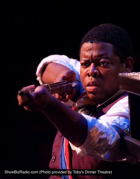 Combeferre, a rebel student, (Tobias Young) prepares to fight the army to the end